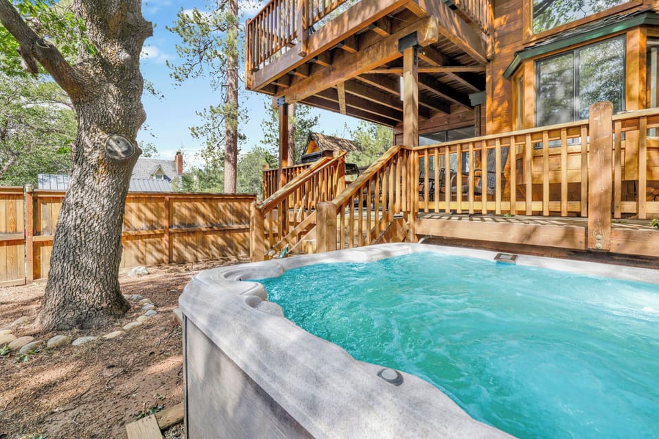 Private outdoor hot tub, surrounded by tall pines, perfect for relaxing under the trees after a day of adventure—enjoy peaceful forest views, fresh air, and a truly rejuvenating stay.
