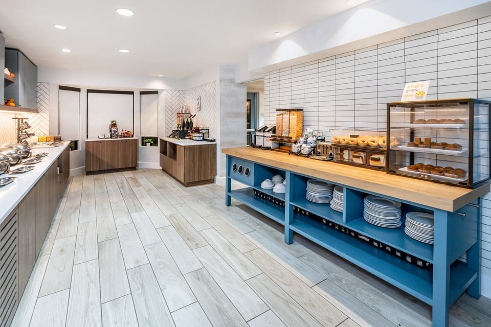 Waffles, bagels, and a rotating selection of hot items — breakfast runs every morning before checkout
