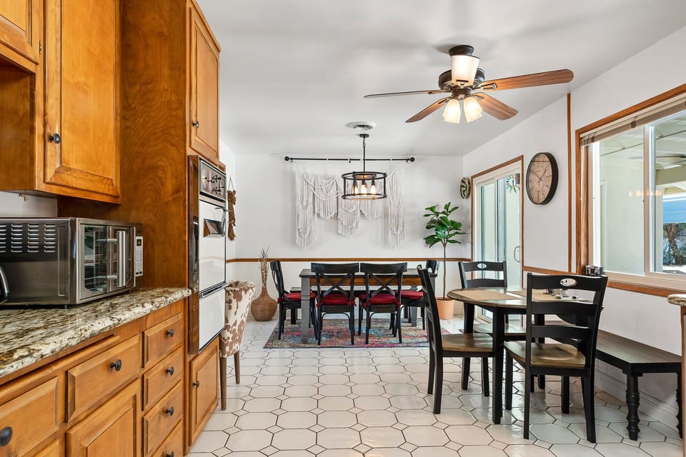 From the kitchen the dining table is set up that seats 6 and with a high chair.