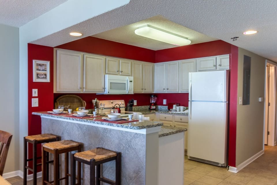 Kitchen includes a breakfast bar with 3 bar stools