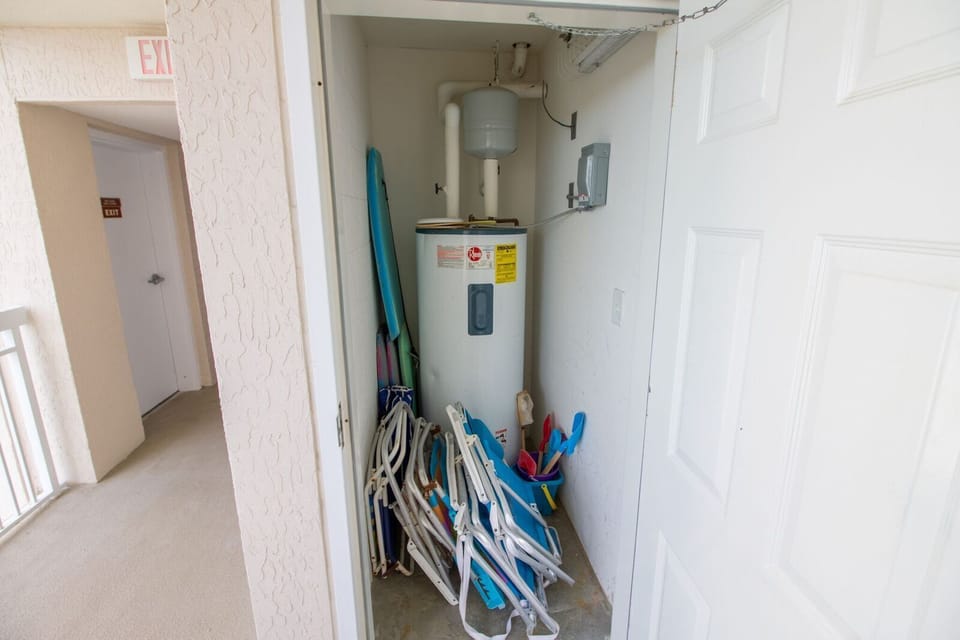 Storage closet outside condo with beach chairs, umbrella, and  beach toys to use