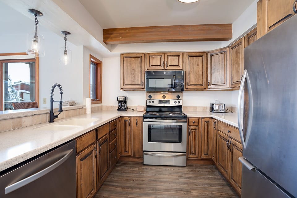 Your fully equipped kitchen features warm wood cabinetry, stainless steel appliances, and granite counters - perfect for creating memorable meals together.