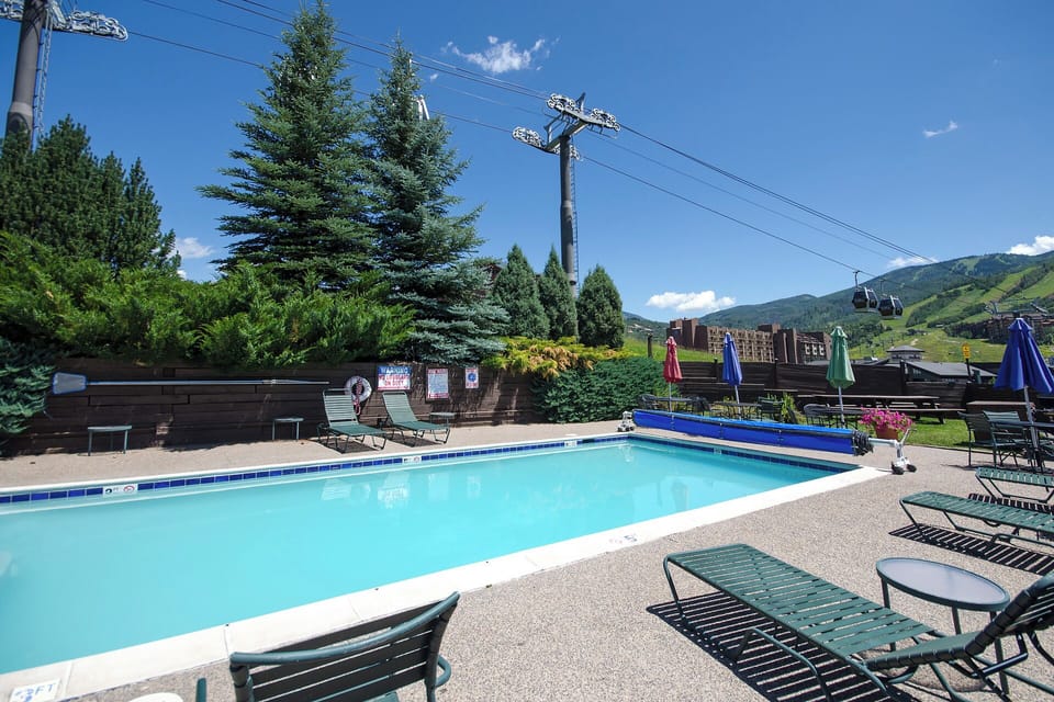 Cool off with a refreshing swim while taking in stunning mountain views from this pristine poolside retreat.