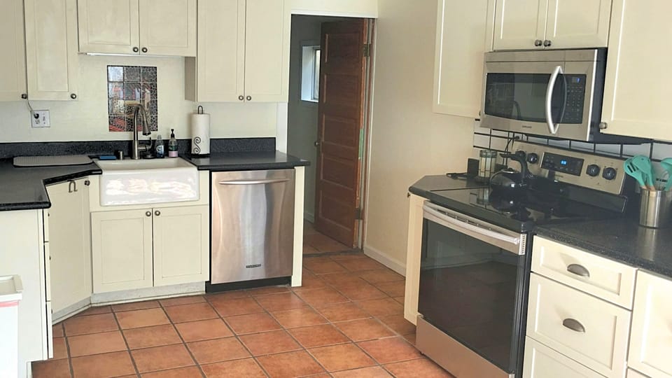 Full kitchen stocked with utensils.