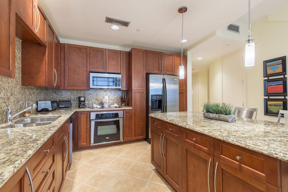 Amazing kitchen fully stocked with cooking utensils and stainless steel appliances!