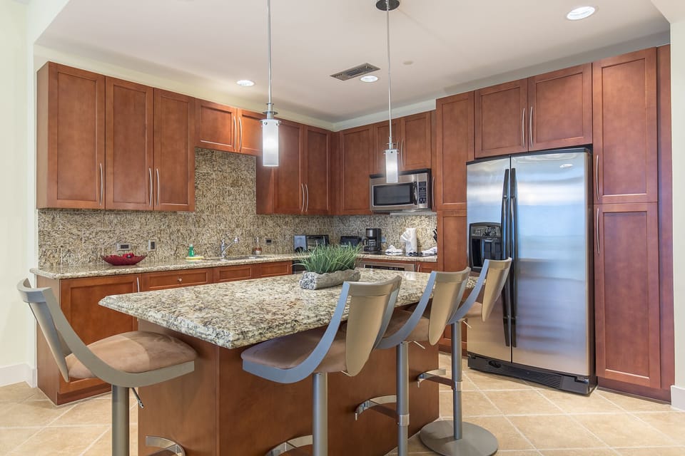 Amazing kitchen fully stocked with cooking utensils and stainless steel appliances!