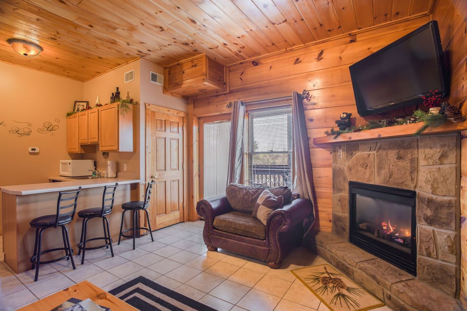 Lounge fireside in the secondary downstairs living room. Take advantage of the convenient kitchenette with a mini-fridge and microwave.