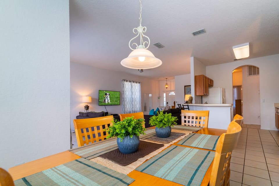 Dining area with seating and open view to living room & kitchen.