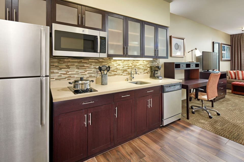 Fully stocked kitchen with stainless steel appliances and cabinet space.
