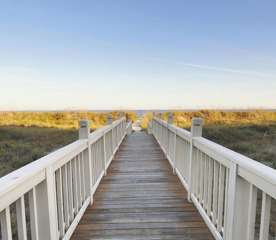 Walkway to beach from PD House. 3 min drive. Beach chairs & umbrellas for use. 