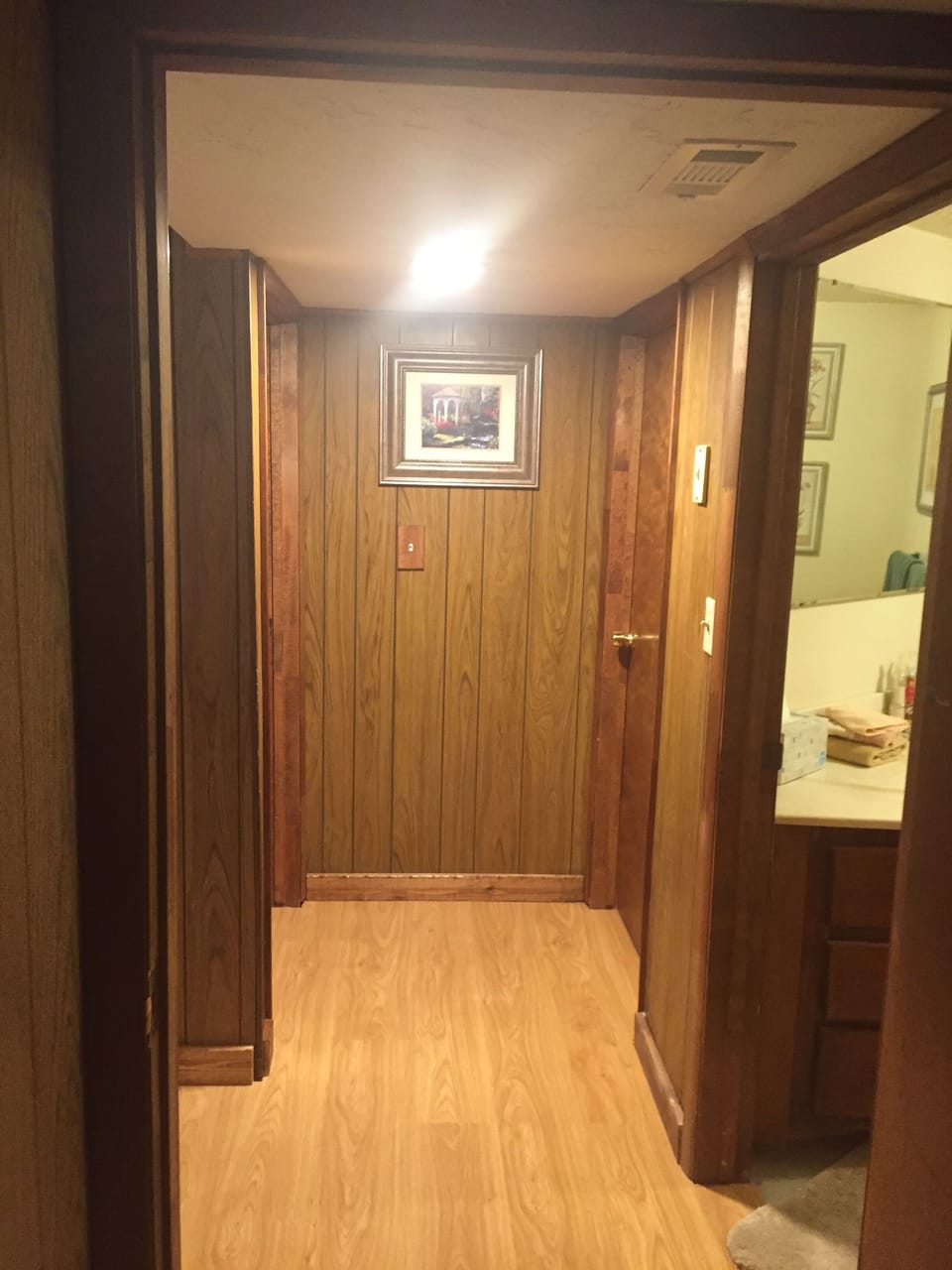 Hallway. Bathroom on the right and bedroom door on the left