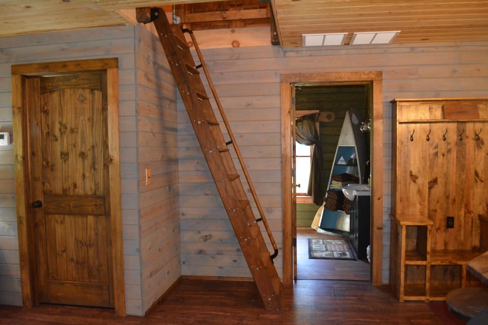 Sturdy stepladder provides access to 2nd floor, with 2 bedrooms and half-bath.