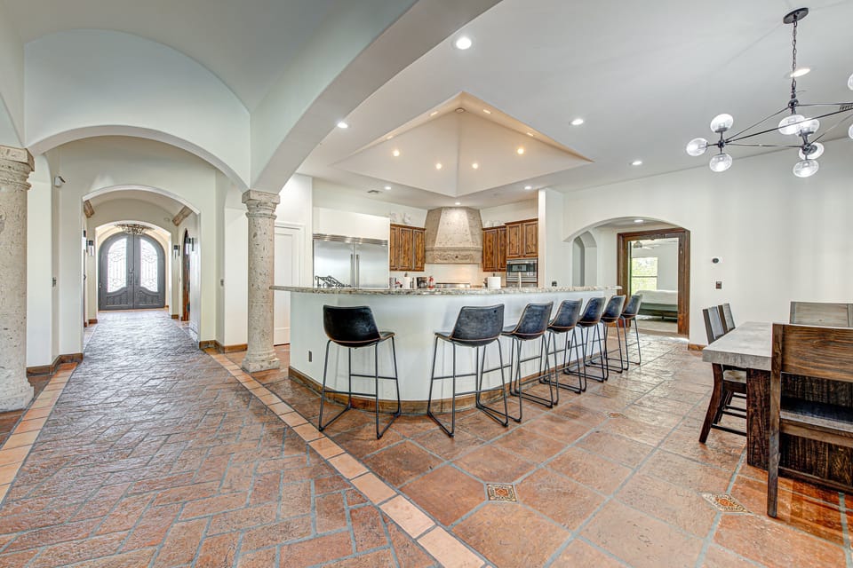 A well-appointed kitchen seamlessly connected to an elegant dining room table.