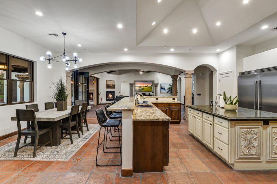 Experience the perfect harmony of the kitchen, dining room, and living room in Casa Palacio.