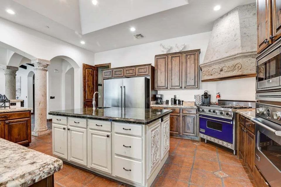 The gleaming countertops and tasteful decor elevate the entire space, creating an atmosphere that invites both culinary creativity and social gatherings.