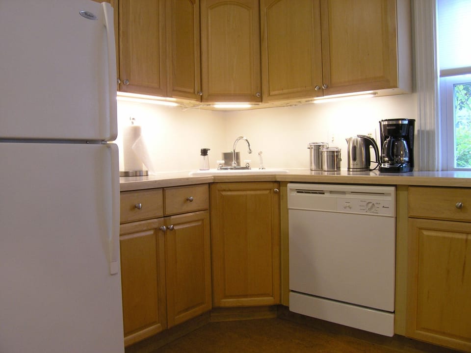 Coffee maker and tea kettle. Full size fridge and dishwasher
