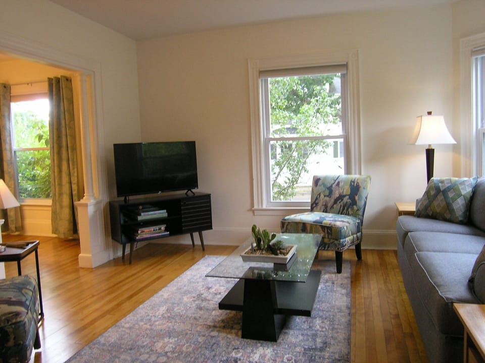 Living room with view of television and dining room