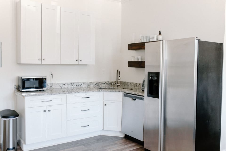 Has a microwave, coffee maker, toaster oven, dishwasher, refrigerator, hotplate