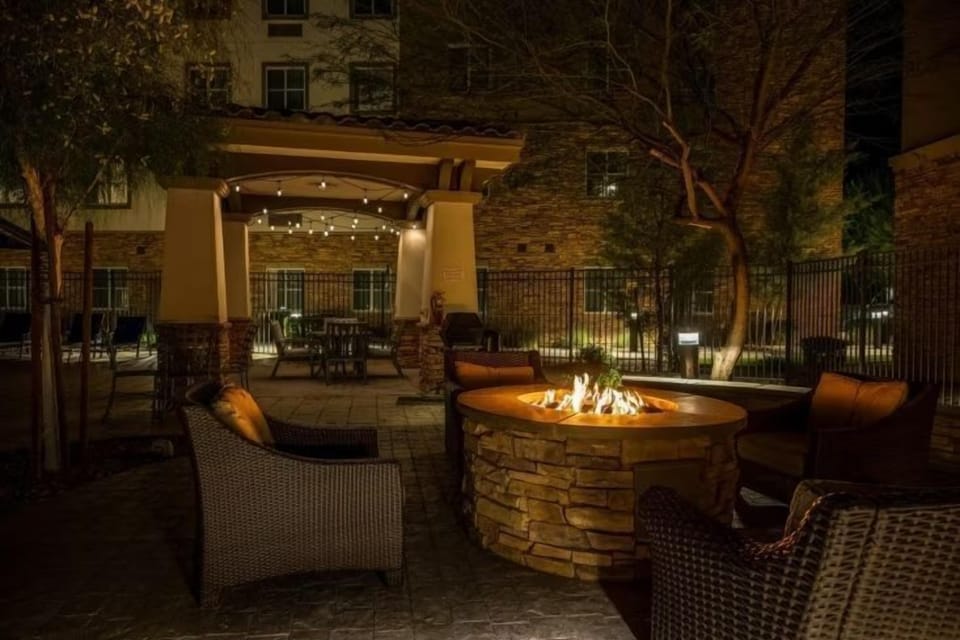 Gather around the outdoor fire pit under string lights.