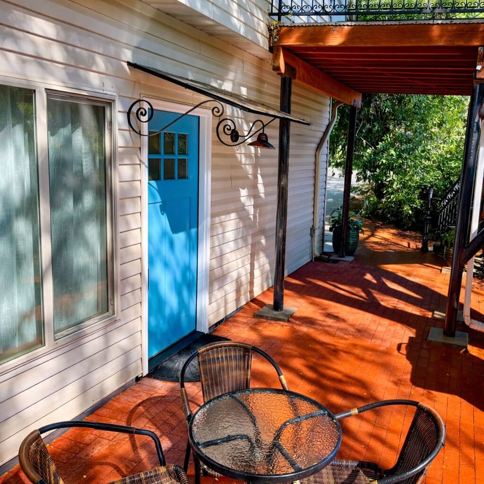 Private fenced patio with seating and grill