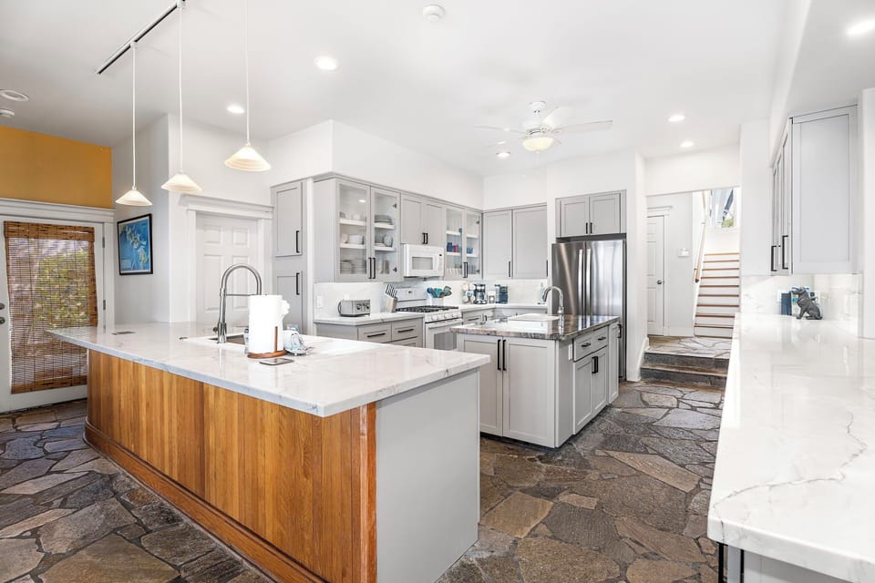 Gas cooktop and deep counters provide professional-grade function for inspired cooking.