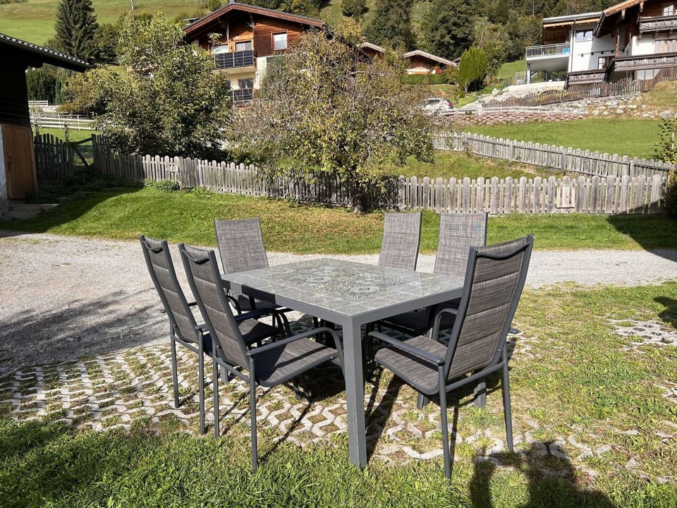 Plant, Table, Furniture, Building, Outdoor Table, Outdoor Furniture, Tree, Land Lot, Chair, Grass