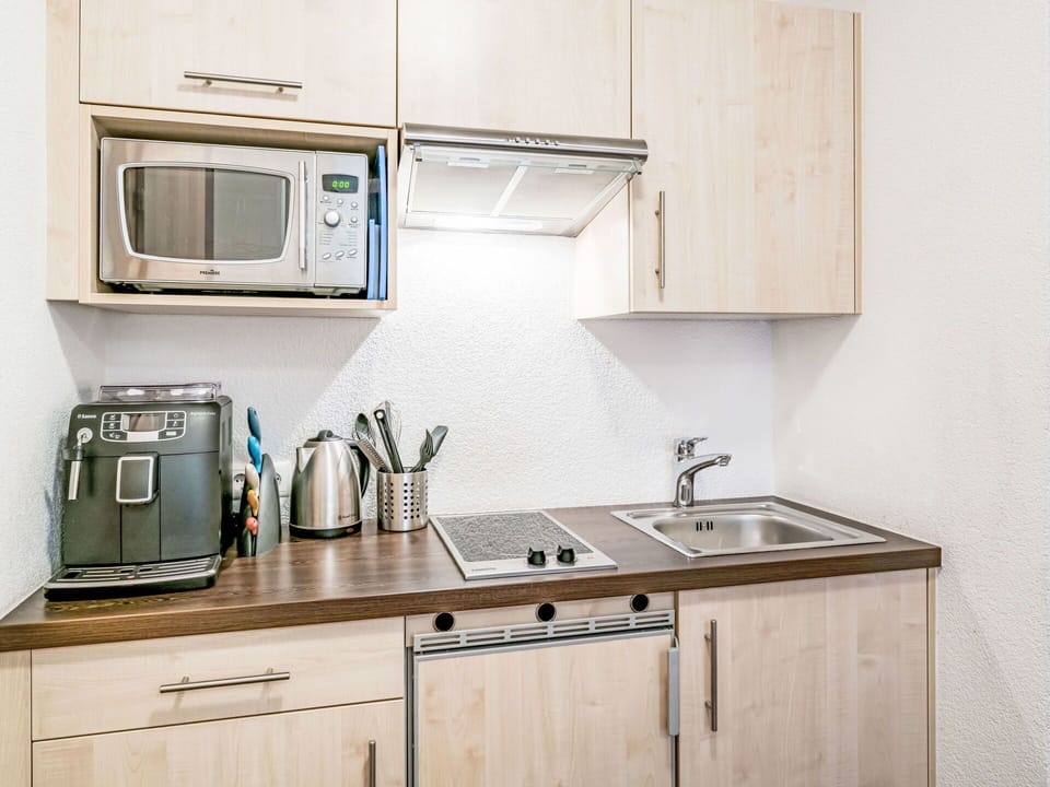 Furniture, Interior Design, Kitchen Appliance, Major Appliance, Kitchen, Countertop, Cabinetry, Room, Flooring, Home Appliance