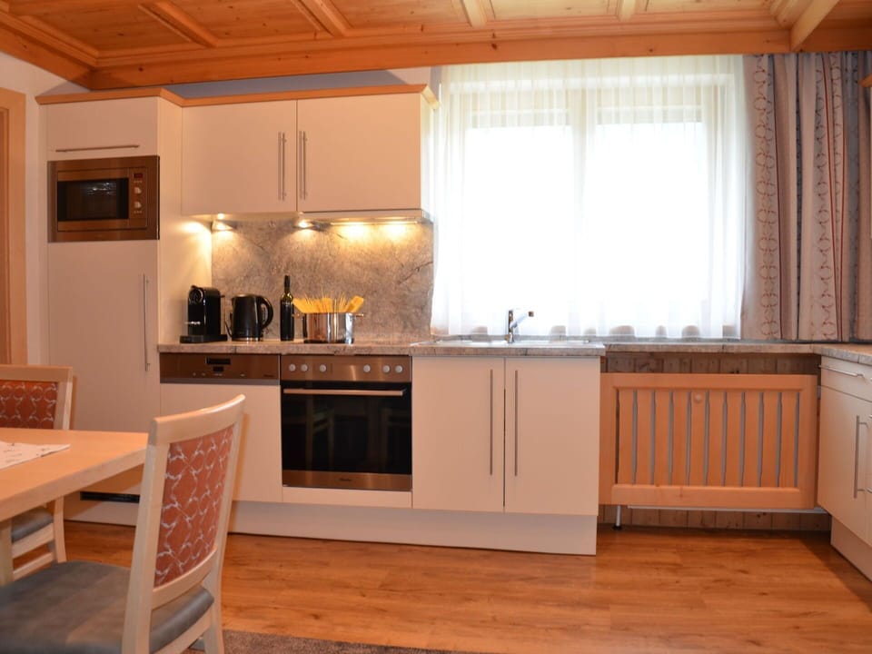 Furniture, Kitchen, Interior Design, Countertop, Flooring, Kitchen Appliance, Wood, Cabinetry, Floor, Ceiling