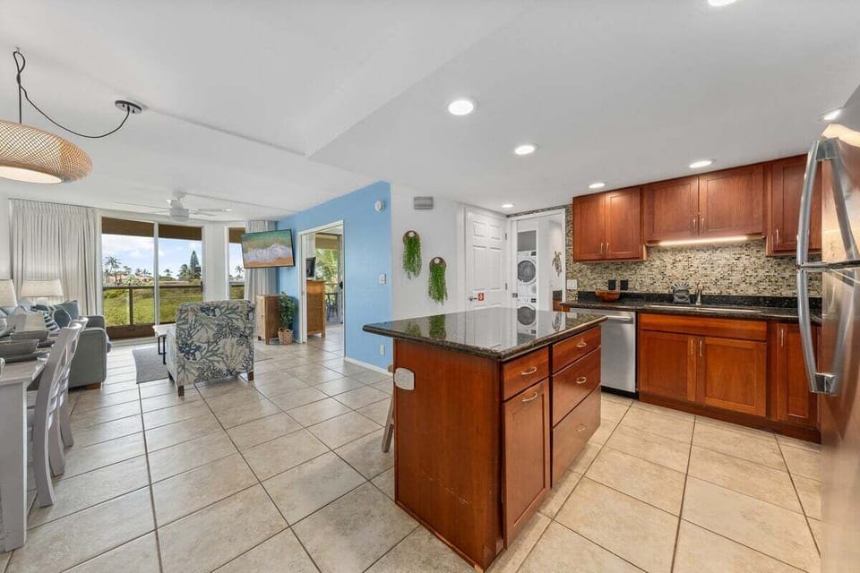 Spacious, and clean kitchen features granite countertop, modern and stainless steel appliances
