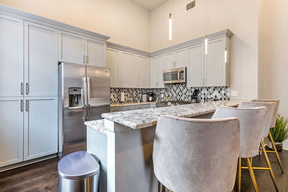 Cook and dine easily in the fully stocked kitchen, equipped with all stainless steel appliances, gas range, basic cookware, and a dining area for a comfortable meal at home. Entertain at the bar with seating for four.