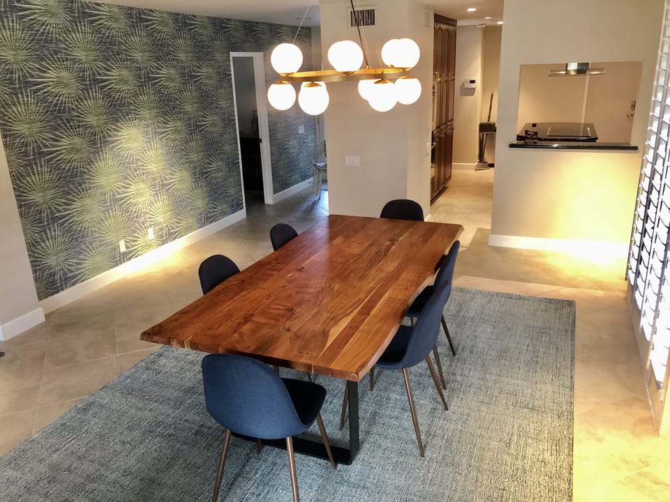 Dining room with kitchen in the background