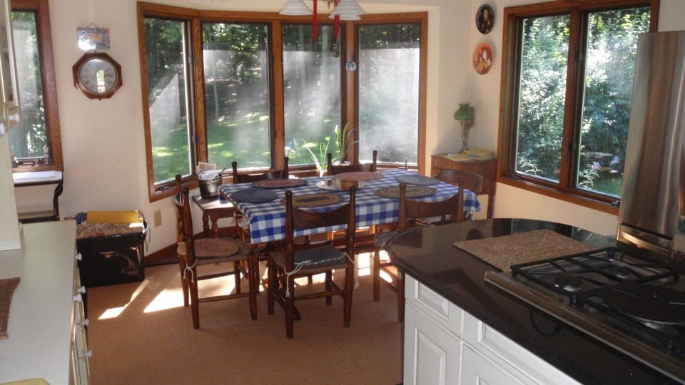 Well equipped modern kitchen with small bar area.