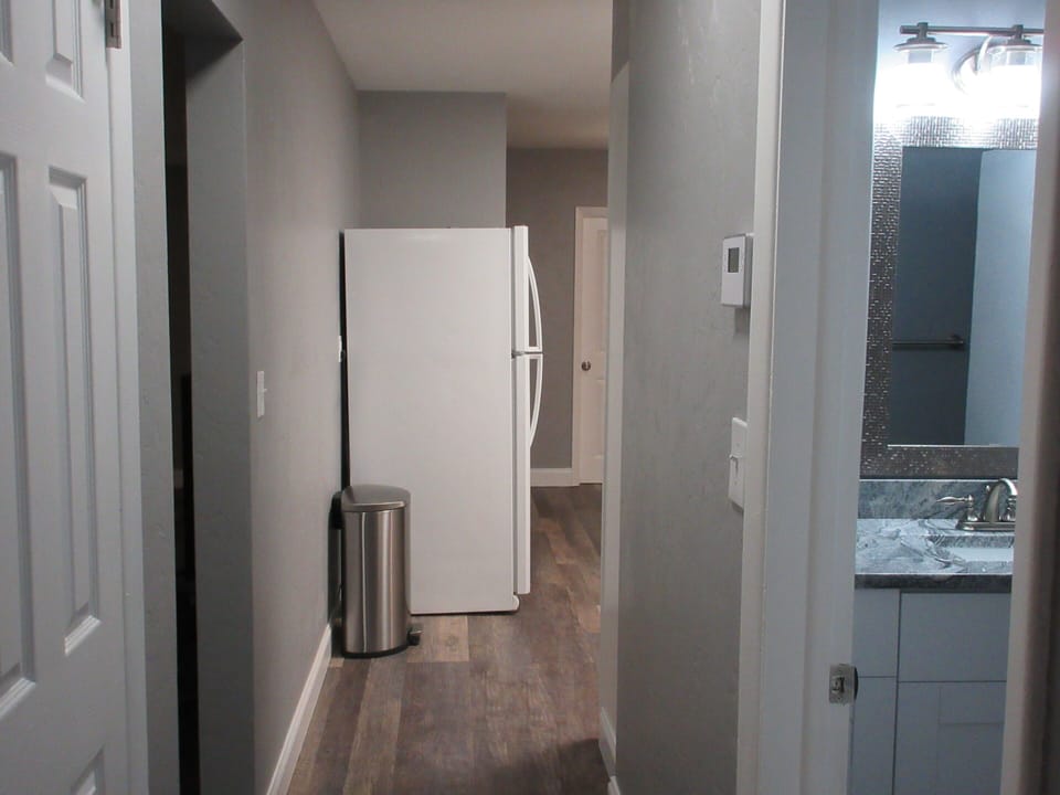 Hallway view from bedrooms 2 and 3 to Kitchen. 