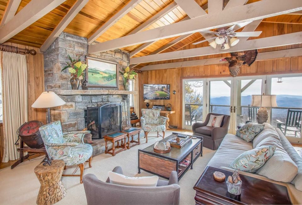 Main Living Area of Out On A Limb with Mountain Views, Stone Wood-Burning Fireplace, and HD Smart TV