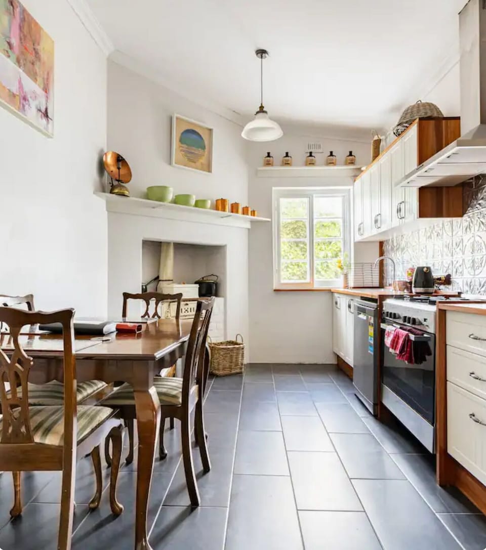 Kitchen showing old Metters stove and current cooking appliances