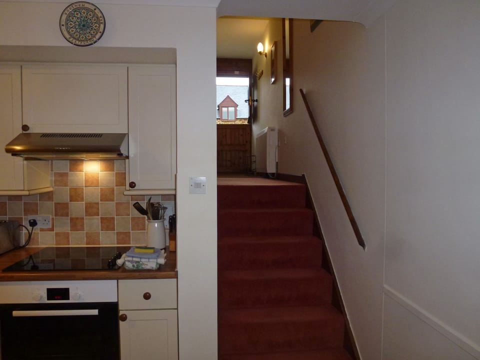 Front stable door, hall & stairs viewed from open plan living area.