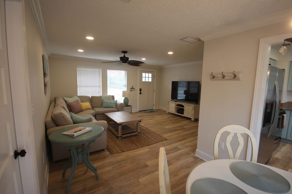Living Room with 65" Smart TV and recessed LED can lights on a dimmer