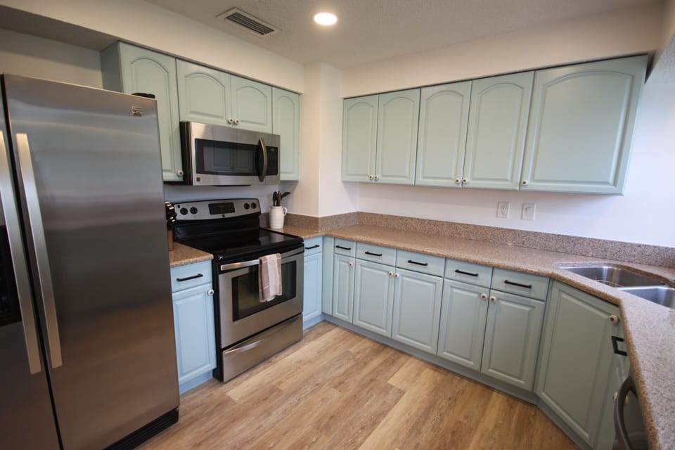Kitchen with side by side refrigerator with water and ice in the door (filtered)