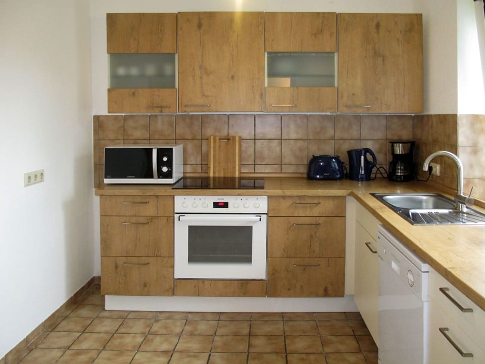 Room, Property, Kitchen, Cabinetry, Furniture, Countertop, Tile, Kitchen Stove, Floor, Interior Design