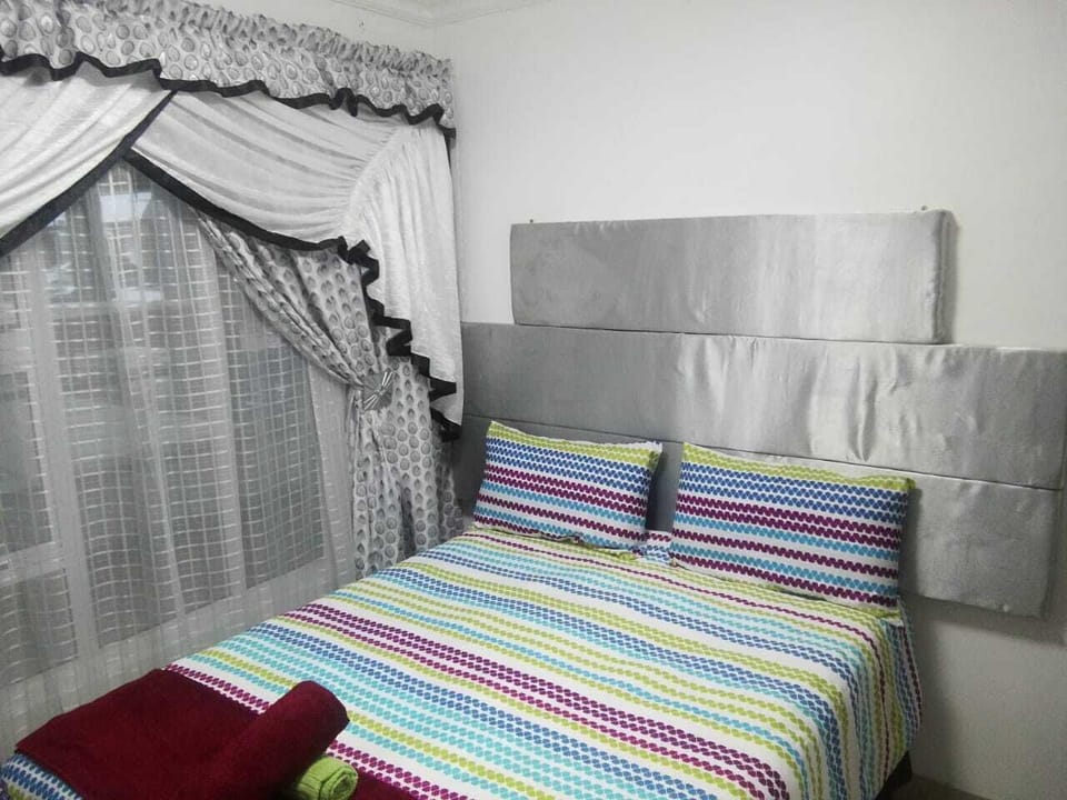 Bedroom 2 with a double bed and built in cupboard.