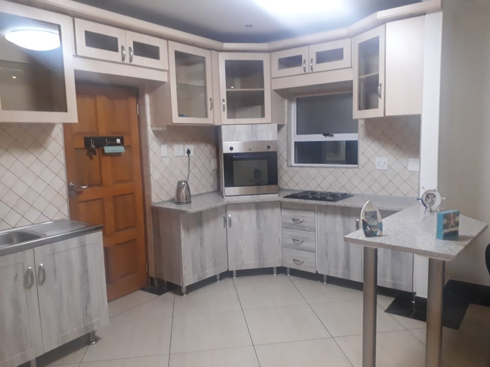 Fully fitted kitchen with hob, oven, microwave, kettle etc.