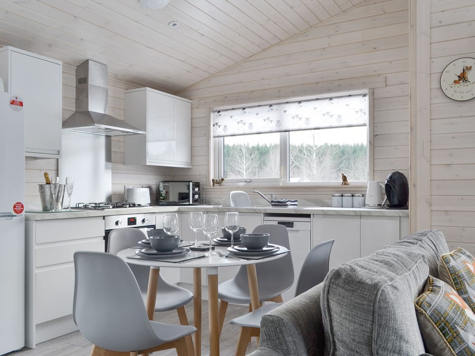 Fully equipped kitchen with dining area within the open-plan design | The Den - Invernahavon, Glentruim, near Newtonmore