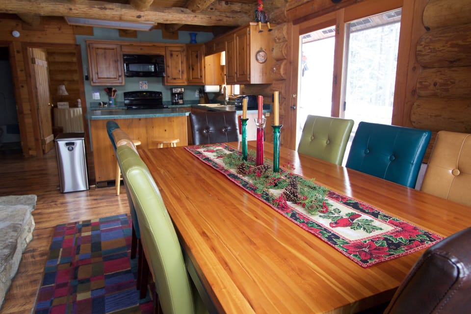 Dining room seats 8 people comfortably and features a two-sided fireplace. 