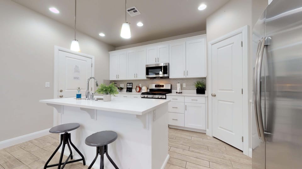 Fully stocked gourmet kitchen featuring extra seating at the bar