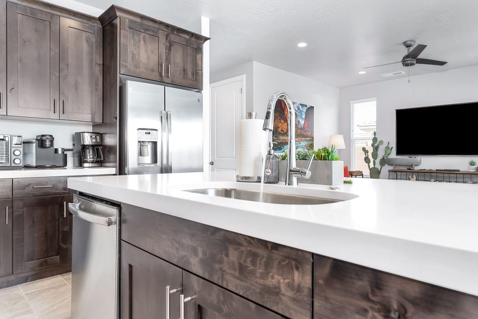 Fully stocked kitchen with stainless steel appliances and solid-surface thick countertops