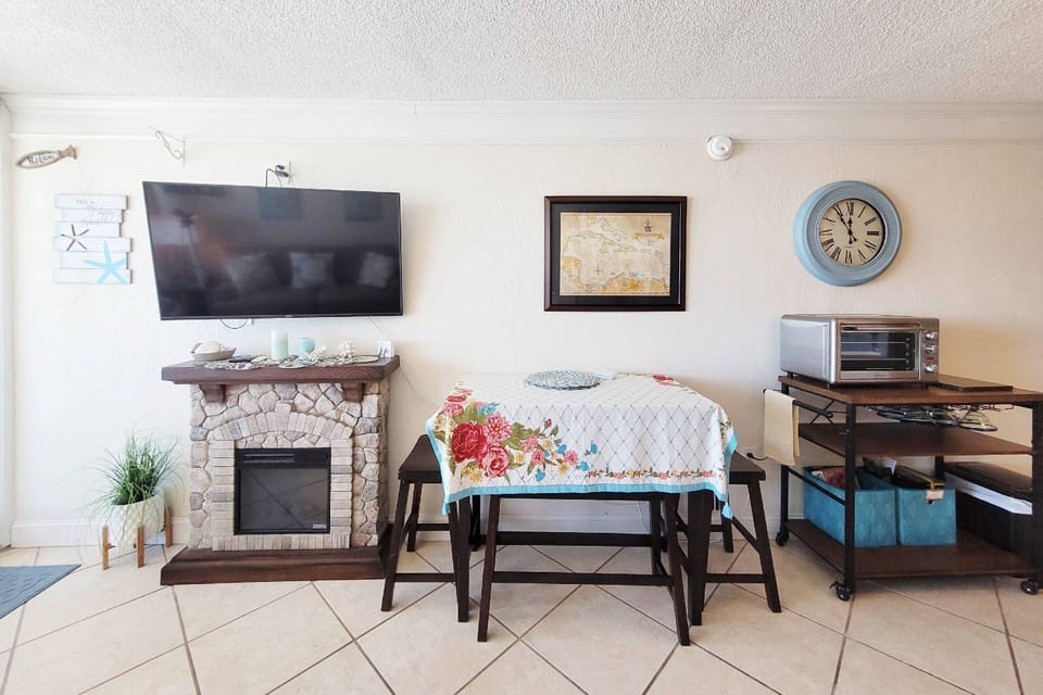 50" flat screen TV, faux operating fire place and dinette.
