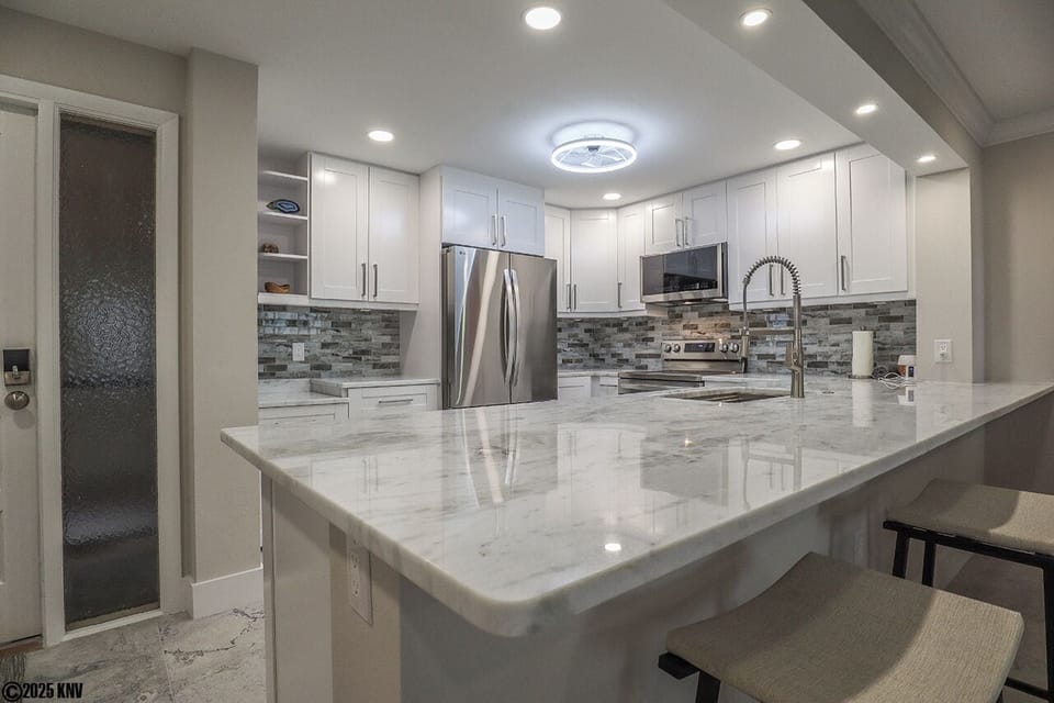 Gorgeous marble countertops, fabulous custom designed cabinets and backsplash and new appliances