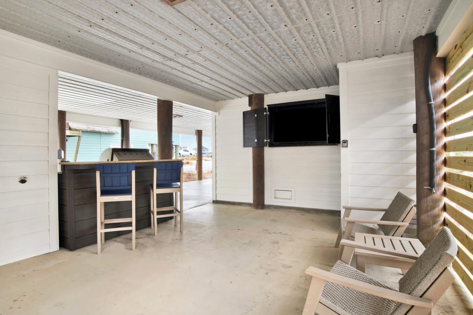 Outdoor area with built in grill area and TV