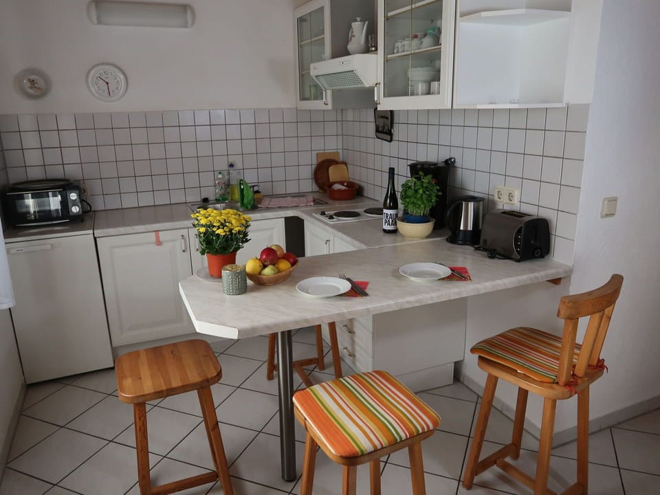 Furniture, Table, Cabinetry, Kitchen, Countertop, Building, Interior Design, Kitchen Stove, Kitchen Appliance, Flooring