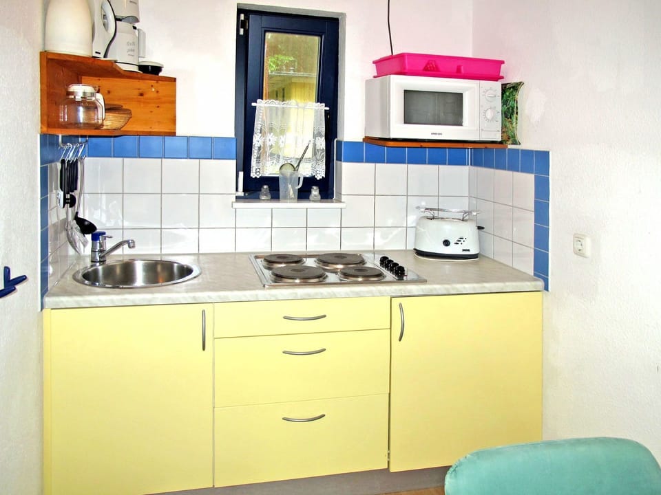 Room, Cabinetry, Furniture, Kitchen, Property, Countertop, Yellow, Interior Design, Sink, Material Property